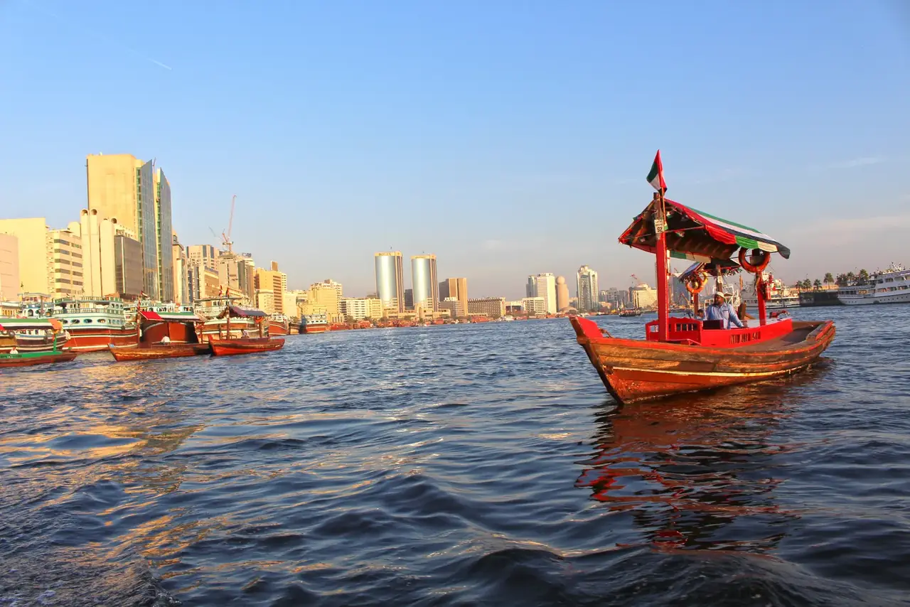 Traditional abra on Dubai Creek at sunset